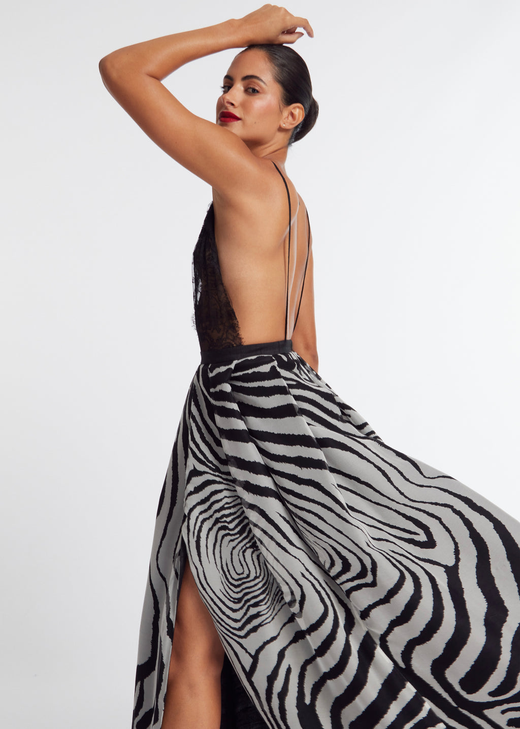 Woman wearing a zebra print skirt with a plain background