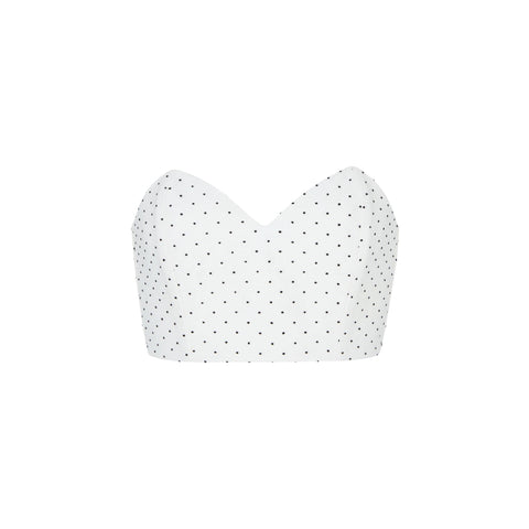 White corset top with black polka dots on a white background
