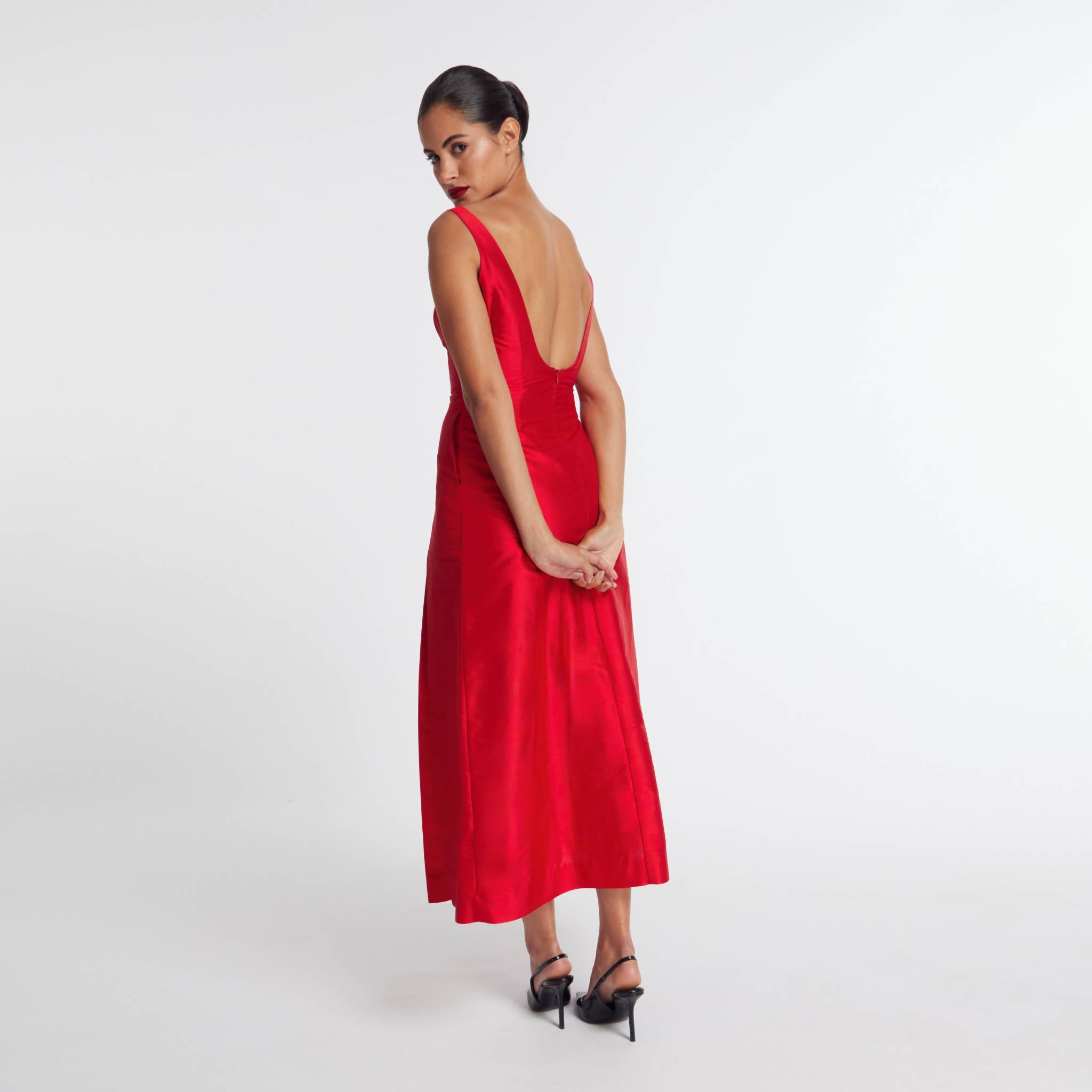 Woman wearing a red dress with a white background